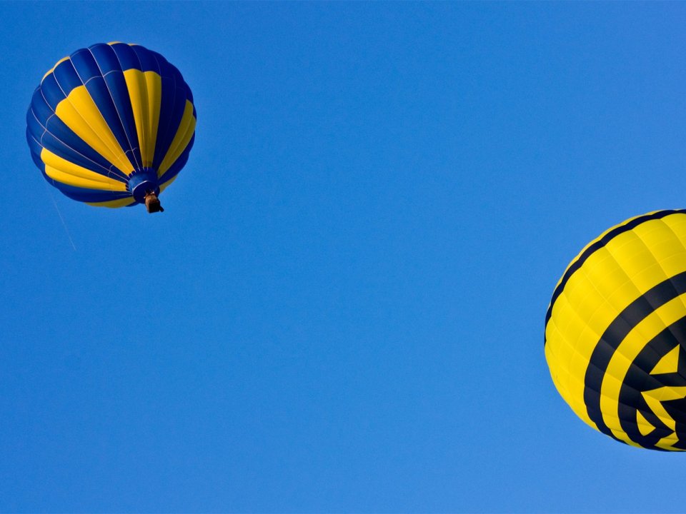 Blue Yellow Hot Air Balloons Flying Under Clear Blue Sky