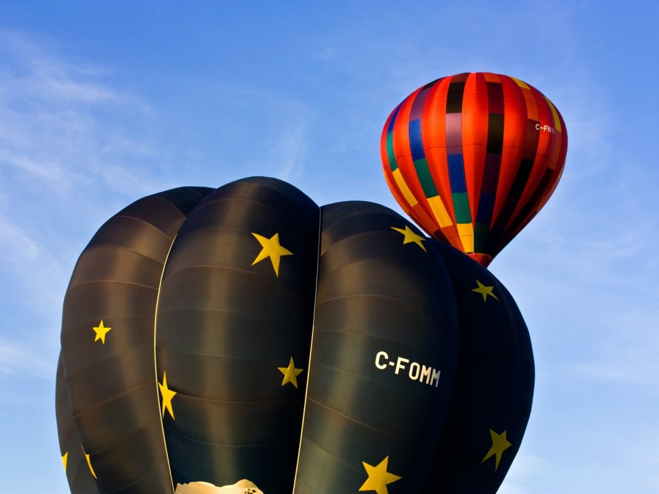 Two Special Paint Hot Air Balloons Flying In Clear Blue Sky