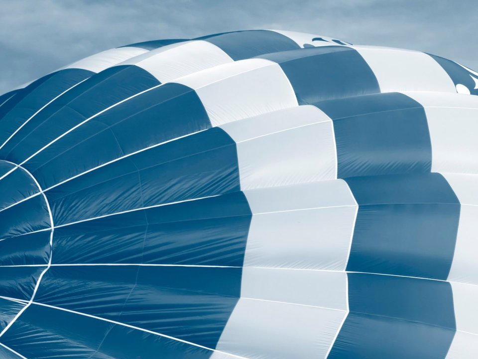 Blue White Striped Hot Air Balloon Closeup Under Cloudy Sky