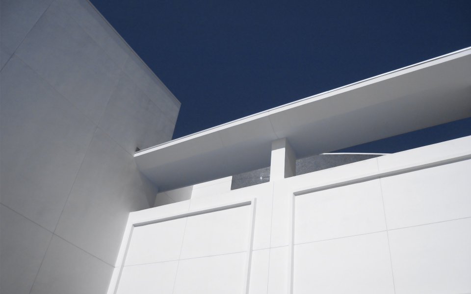Low Angle Shot Of White Minimalist Modern Building Under Deep Blue Sky