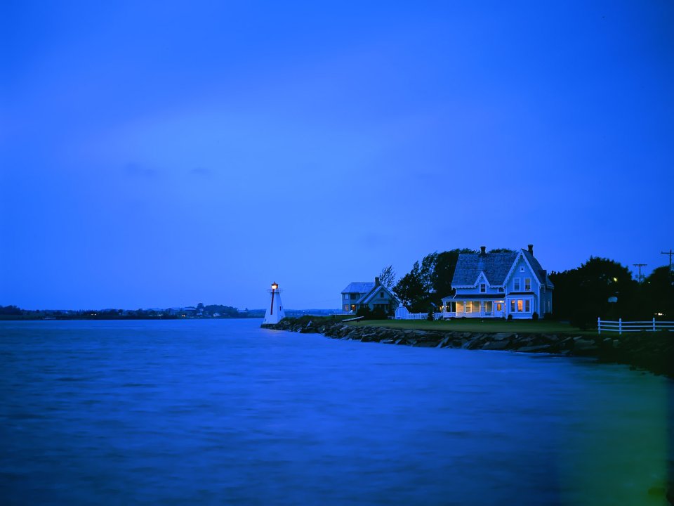 Coastal Lighthouse And House At Blue Hour