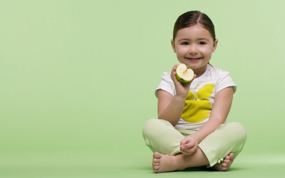 Smiling Little Girl Holding Green Apple Light Green Background Portrait