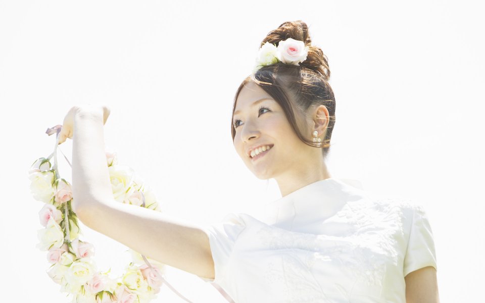 Smiling Bride Holding Rose Wreath At Sunny Outdoor Wedding