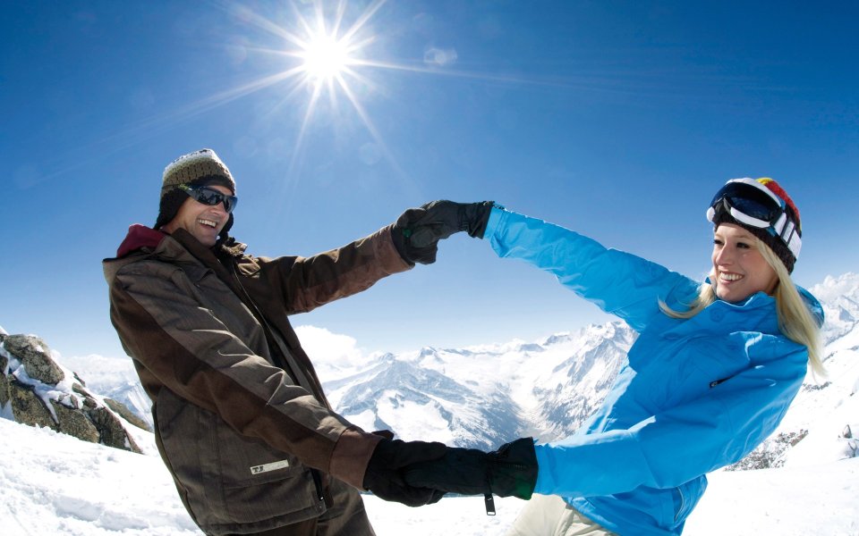 Happy Couple On Snowy Mountain