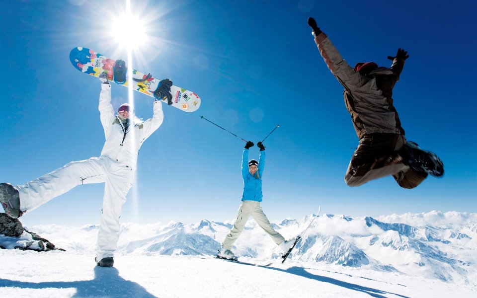 Skiing And Snowboarding Fun On Mountain Peak