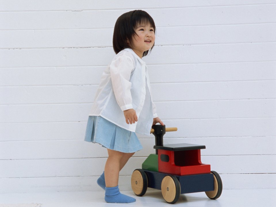Cute Asian Little Girl Pushing Wooden Toy Car Home Portrait