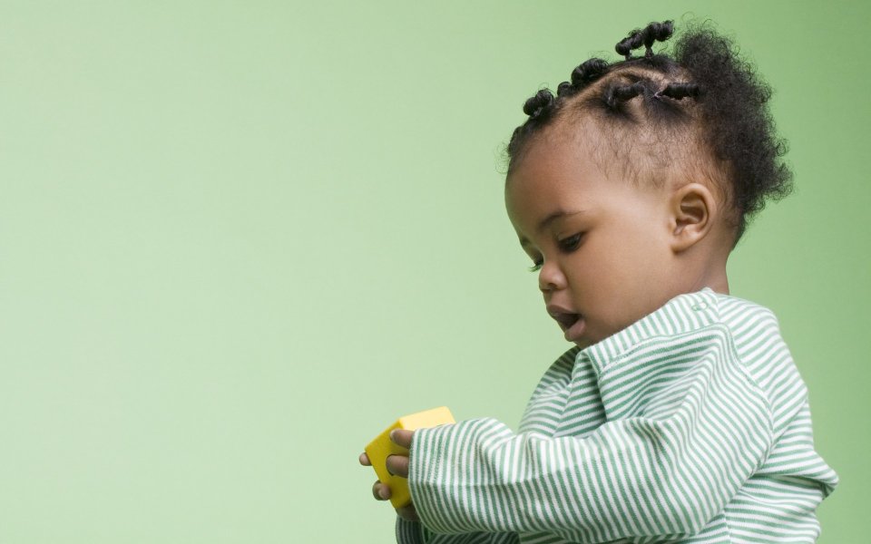 Cute Black Toddler Playing Yellow Building Block Light Green Background