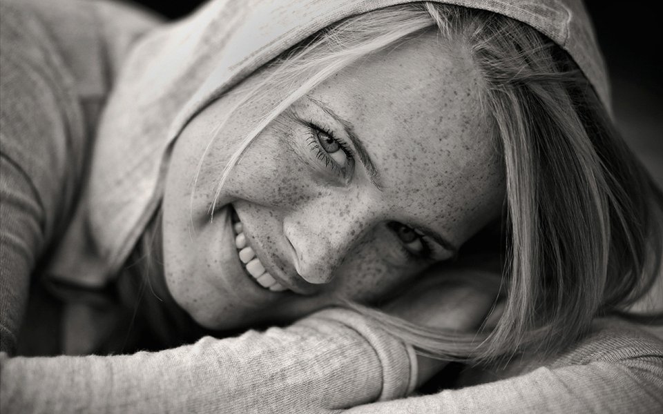 Smiling Freckled Woman In Hoodie Black And White Portrait