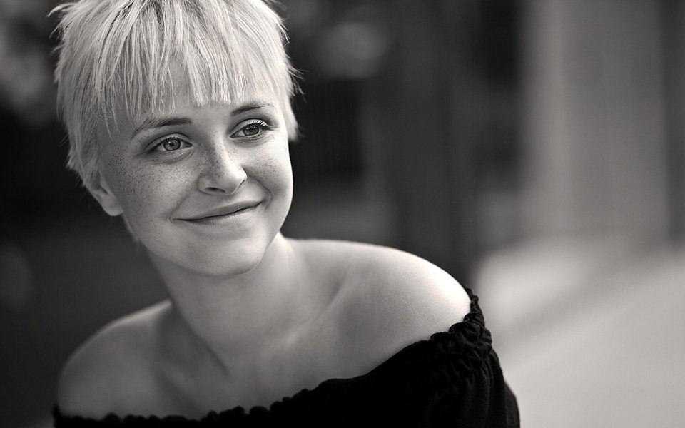Black And White Portrait Of Smiling Short Haired Freckled Woman