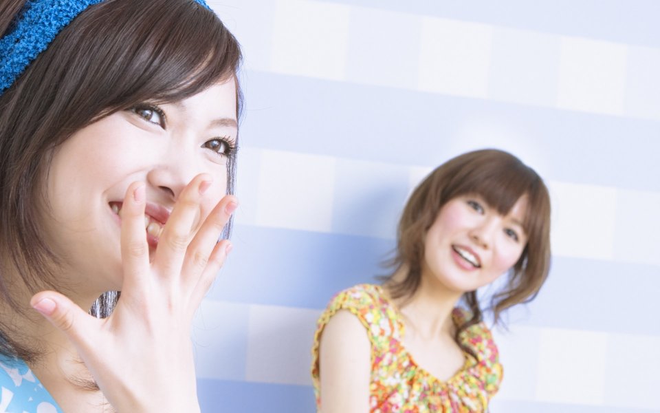Two Smiling Japanese Young Girls At Home Portrait