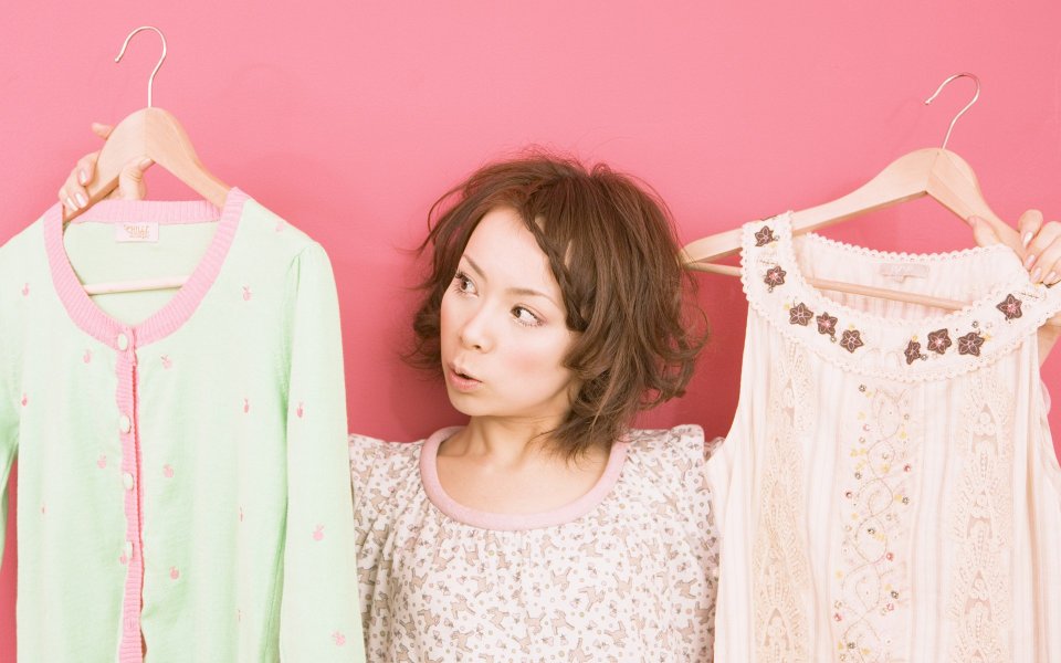 Playful Japanese Girl Choosing Cute Macaron Clothes Pink Background