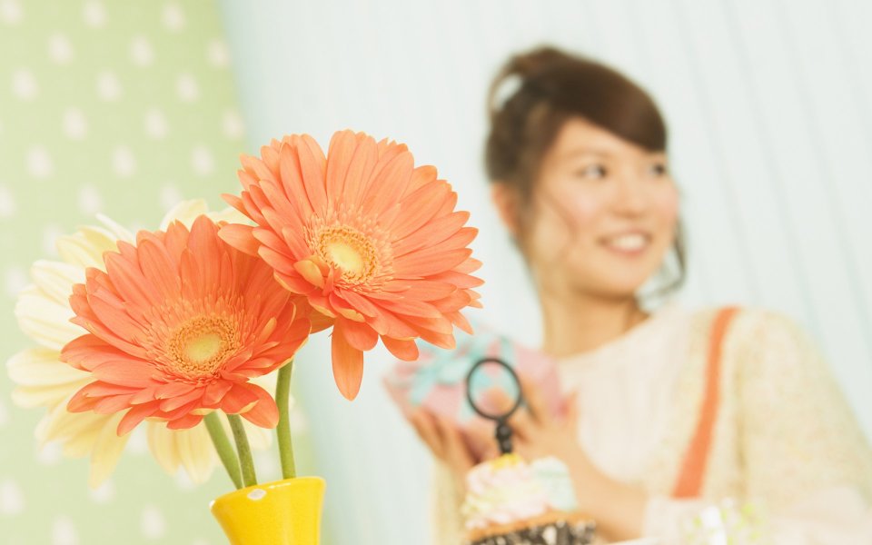 Orange Gerbera Flowers And Smiling Girl At Home