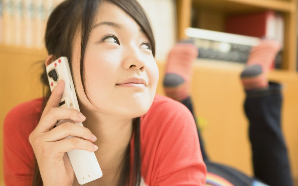 Relaxed Young Girl Talking On Landline Phone At Home