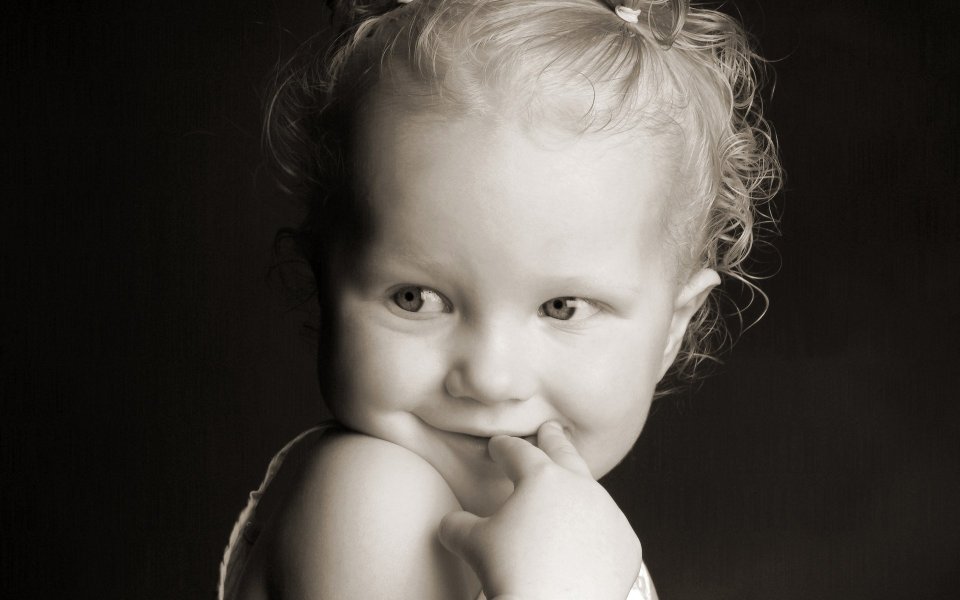 Black And White Vintage Photo Of Cute Little Girl Biting Finger