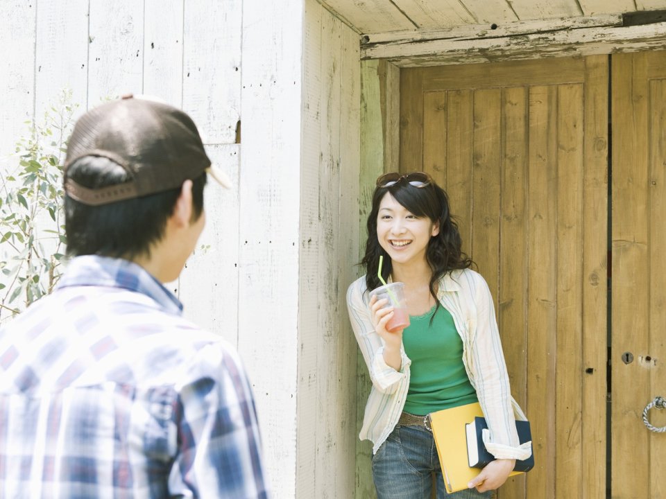 Young Couple Sweet Interaction In Front Of Wooden Cabin
