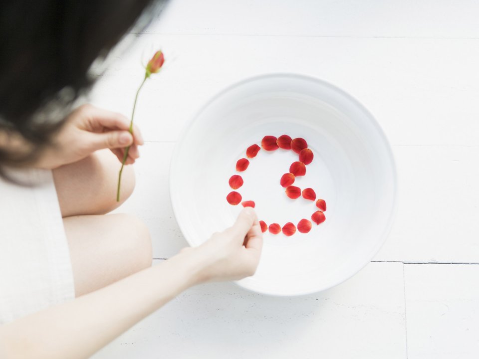 Young Girl Arranging Rose Petals To Make Number Relaxing Home Time