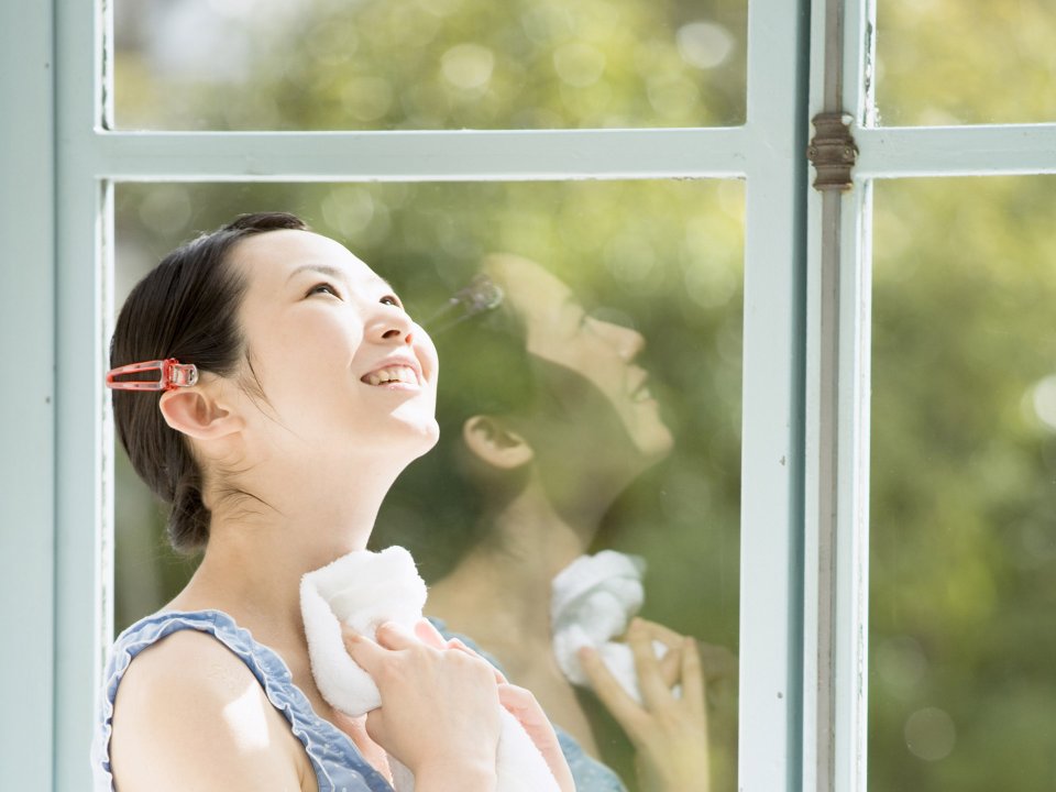 Relaxing Young Woman Smiling By Window Enjoying Summer Sunshine