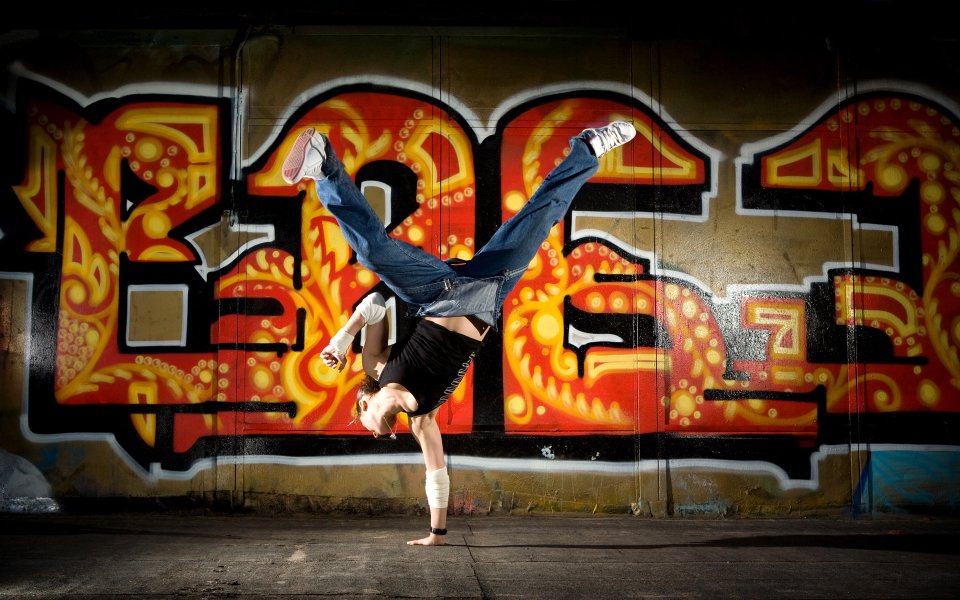 Breakdancer One Hand Handstand In Front Of Graffiti Wall