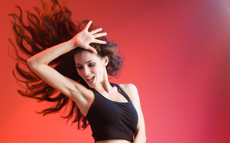 Dancing Energetic Woman With Flying Long Hair Red Gradient Background