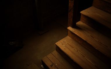 Dim Old Wooden Staircase In Abandoned Basement