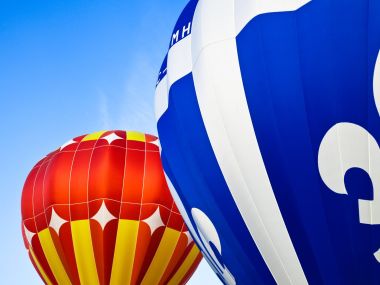 Colorful Hot Air Balloons Under Clear Blue Sky Closeup