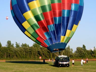 Colorful Hot Air Balloon Preparing Takeoff On Grass Field