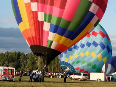 Hot Air Balloons Preparing For Launch At Outdoor Festival