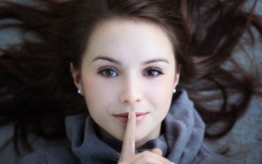 Young Woman Shushing Portrait Closeup Photo