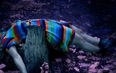 Surreal Concept Photo Person In Rainbow Stripe Dress Lying On Tree Stump