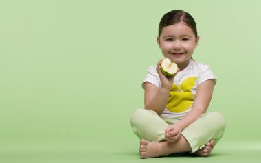 Smiling Little Girl Holding Green Apple Light Green Background Portrait