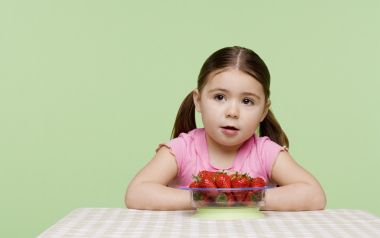 Cute Little Girl With Fresh Strawberries Studio Portrait