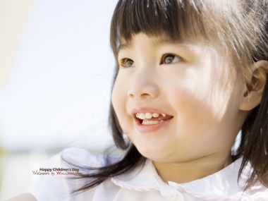 Cute Asian Little Girl Smiling In Sunshine Childrens Day Portrait
