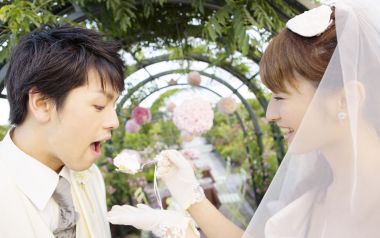 Bride Feeding Groom Wedding Cake At Garden Wedding Reception