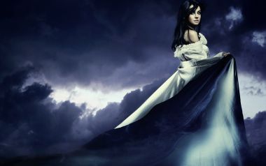Fantasy Portrait Of Black Haired Woman With Long Dress Under Dark Purple Clouds