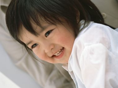 Cute East Asian Little Girl Bright Smile Portrait Closeup
