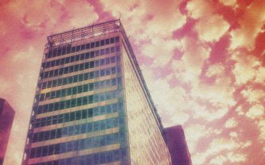 Vintage Style Skyscraper Under Cloudy Sky