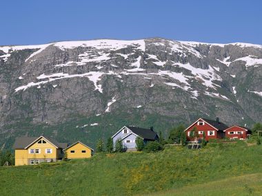 Colorful Wooden Houses Under Snowy Mountains In Mosjoen Norway