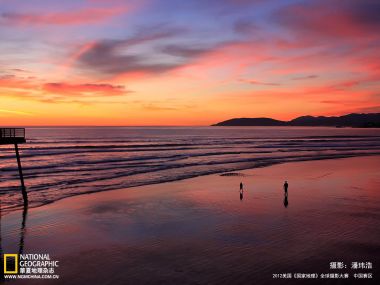 Stunning Coastal Sunset People Silhouettes Walking On Sandy Beach