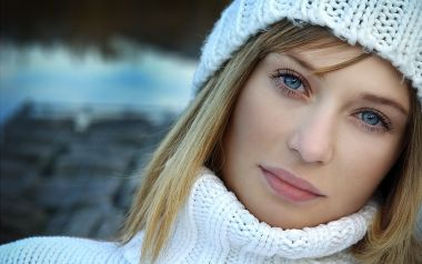 Winter Outdoor Portrait Of Blonde Blue Eyed Woman In White Knitwear