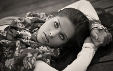 Black And White Portrait Of Elegant Young Woman Lying On Wooden Floor