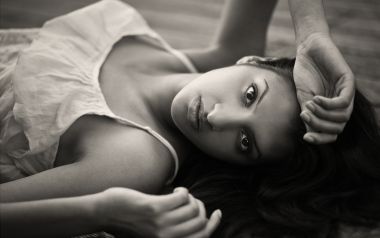 Black And White Emotional Portrait Of Lying Female At Home