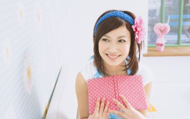 Sweet Japanese Home Girl Holding Pink Polka Dot Notebook Portrait
