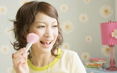 Young Japanese Girl Holding Blush Brush At Home Portrait