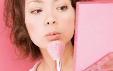 Young Girl Applying Makeup With Pink Brush And Mirror Closeup