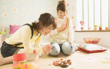 Two Young Girls Enjoy Afternoon Tea In Bright Japanese Home
