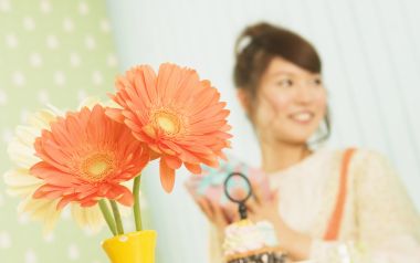 Orange Gerbera Flowers And Smiling Girl At Home