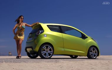 Bright Green Chevrolet Beat With Fashion Woman On Summer Beach