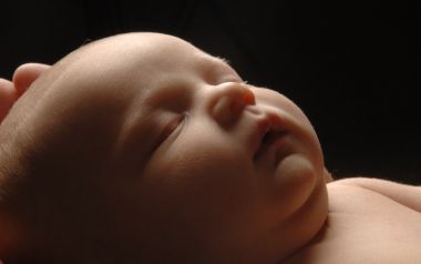 Close Up Of Sleeping Newborn Baby Under Soft Light