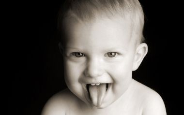 Cute Baby Sticking Out Tongue Black And White Portrait