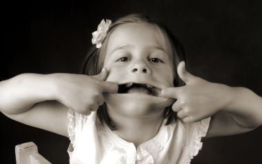 Black And White Portrait Photography Of Little Girl Stretching Her Mouth